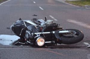 A motorcycle lying tipped over in the road after a collision